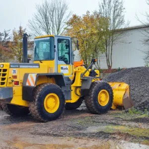 gelber Radlader beim schaufeln von Kies